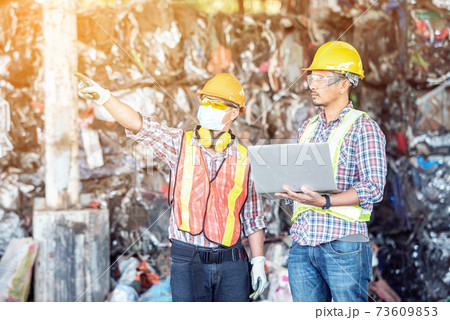 Professional Industrial Mechanical Engineer with Factory Worker while Using Laptop Computer Professional Industrial Mechanical Engineer with Factory Worker while Using Laptop Computer 73609853