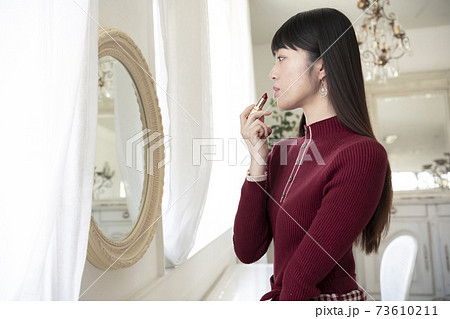 鏡を見てルージュ(口紅)を塗る女性 鏡を見てルージュ(口紅)を塗る女性 73610211