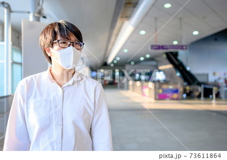 Asian man wearing mask at skytrain station Asian man wearing mask at skytrain station 73611864