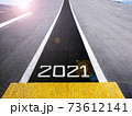 Start and look ahead to the future in new year two thousand twenty one (2021), painted on a runway of an aircraft carrier with lens flair effect 73612141