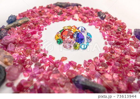colorful diamonds surrounded by raw pink gemstones. colorful diamonds surrounded by raw pink gemstones. 73613944