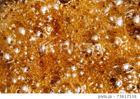 Preparation of sugar candies at home.A taste of our childhood.Background, sugar bubbles Texture.Boiling caramel sugar 73617538