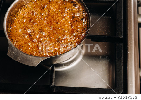 Preparation of sugar candies at home.A taste of our childhood.Rooster lollipops.Boiling Sugar caramel 73617539