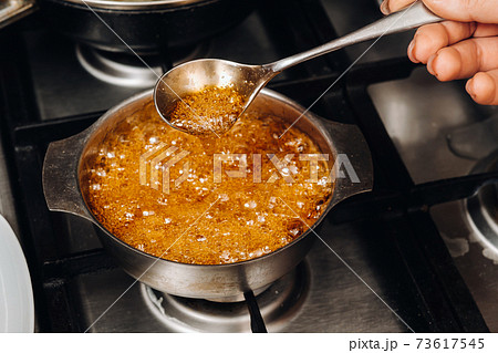 Preparation of sugar candies at home.A taste of our childhood.Rooster lollipops.Boiling Sugar caramel 73617545