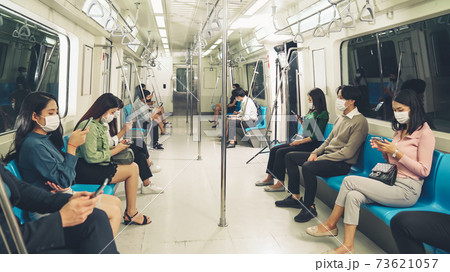Crowd of people wearing face mask on a crowded public subway train travel 73621057
