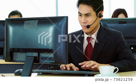 Business people wearing headset working in office Business people wearing headset working in office 73621259