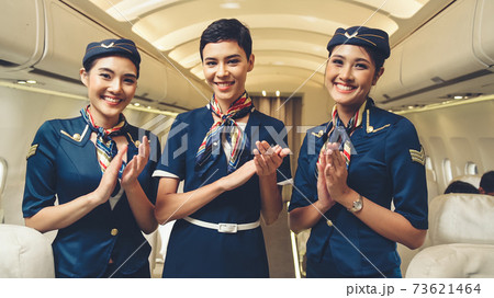 Group of cabin crew or air hostess in airplane Group of cabin crew or air hostess in airplane 73621464