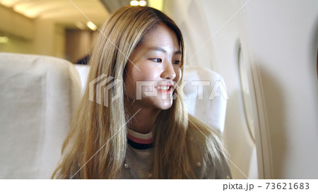 Happy asian woman travel in airplane 73621683