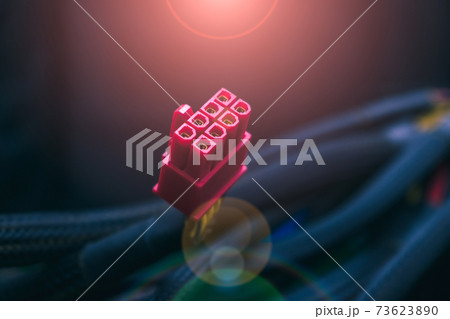 Computer power connector from power supply close-up in rays of light and glare 73623890