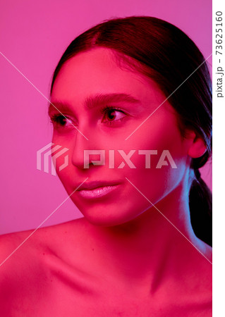 Beautiful east woman portrait isolated on pink studio background in neon light, monochrome 73625160