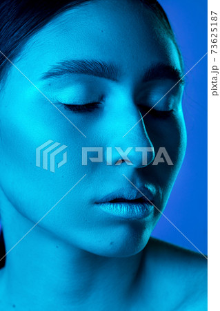 Beautiful east woman portrait isolated on gradient studio background in neon light, monochrome 73625187