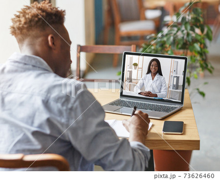 Appointment with doctor online. Black guy having video chat with therapist, receiving professional medical help remotely Appointment with doctor online. Black guy having video chat with therapist, receiving professional medical help remotely 73626460