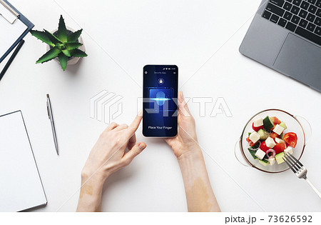 Lady Holding Smartphone With Biometric Verification Application At Workplace, Cropped Lady Holding Smartphone With Biometric Verification Application At Workplace, Cropped 73626592