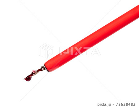 red ink drop and bubble on the nib of dip pen 73628482