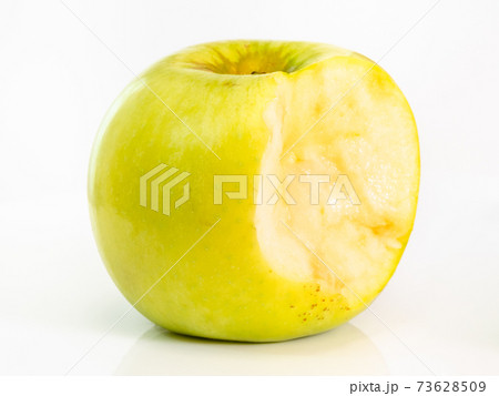 bitten yellow apple fruit on plate on white bitten yellow apple fruit on plate on white 73628509