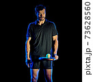 Paddle tennis player man light painting isolated black background 73628560