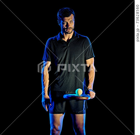 Paddle tennis player man light painting isolated black background 73628560