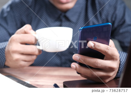 man working from home using smart phone man working from home using smart phone 73628757