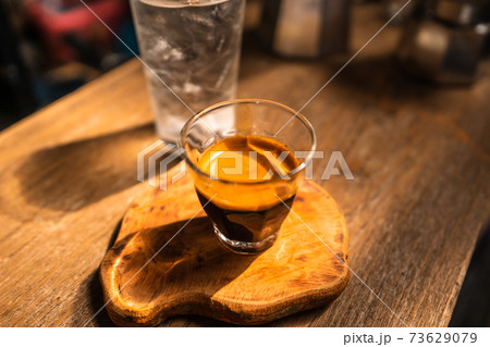 Espresso coffee is flowing into the shot cup. 73629079