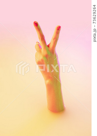 Close up female hand gesturing from the milk bath with soft glowing in neon light Close up female hand gesturing from the milk bath with soft glowing in neon light 73629264
