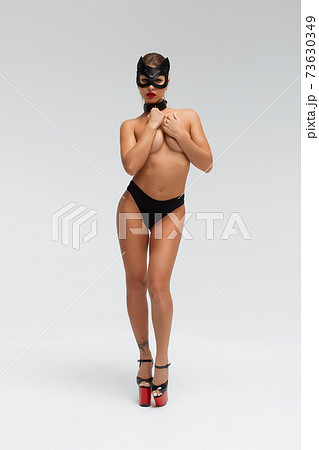Sexy topless woman in black mask Sexy topless woman in black mask 73630349