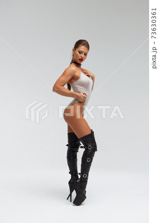 Alluring Young Woman In Black Underwear And Boots Stock Photo
