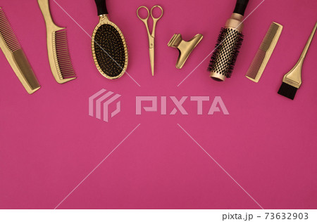 Banner with hairdressing tools. Gold hair salon accessories on pink background with space for text. Banner with hairdressing tools. Gold hair salon accessories on pink background with space for text. 73632903