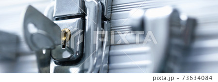 Close-up of a car key inserted in a car door lock Close-up of a car key inserted in a car door lock 73634084