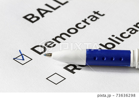 Checklist concept. Closeup of ballot paper with words Democrat and Republican and a pen on it. A checkmark for Democrat in the checkbox. Checklist concept. Closeup of ballot paper with words Democrat and Republican and a pen on it. A checkmark for Democrat in the checkbox. 73636298