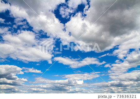 Blue sky background with white clouds 73636321