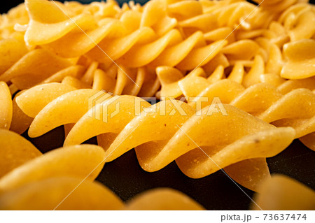 Macro photo of dry heap of fusilli pasta 73637474