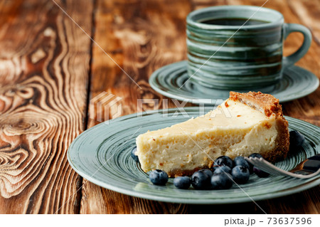 Piece of classic cheesecake on green plate Piece of classic cheesecake on green plate 73637596