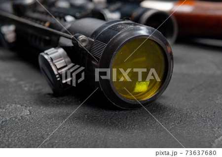 Optical sight of hunting rifle on grey background Optical sight of hunting rifle on grey background 73637680