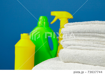 Bottle of detergent whith washing machine, indoors Bottle of detergent whith washing machine, indoors 73637744
