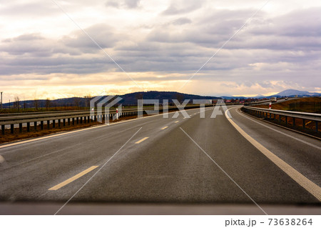 Empty track outside city with fields and road marking Empty track outside city with fields and road marking 73638264