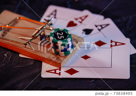 Mousetrap on playing cards and casino chips close-up. Game addiction concept Mousetrap on playing cards and casino chips close-up. Game addiction concept 73638405