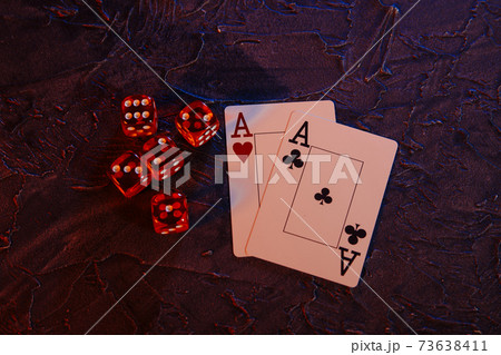 Online gambling сoncept. Aces and five red dices on a grey background Online gambling сoncept. Aces and five red dices on a grey background 73638411