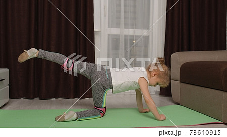 Child kid training gymnastics stretching at home, children girl making sport workout exercises 73640915