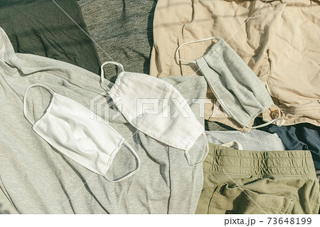 Hygienic mask and clothes being dried on hot sun to kill virus. Hygienic mask and clothes being dried on hot sun to kill virus. 73648199