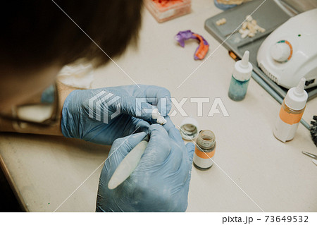 Dental technician work. prosthesis production. teeth prototype construction Dental technician work. prosthesis production. teeth prototype construction 73649532