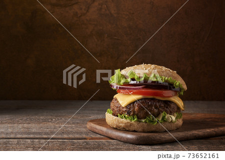Delicious meat burger on rustic and wooden background. Place for text. Delicious meat burger on rustic and wooden background. Place for text. 73652161