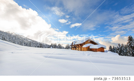 Alpine hut in the midst of lots of snow on the Italian Alps 73653513