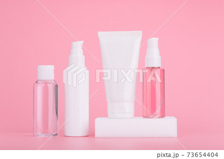 Set of skincare cosmetics against bright pink background. Concept of daily skincare routine and beauty products Set of skincare cosmetics against bright pink background. Concept of daily skincare routine and beauty products 73654404