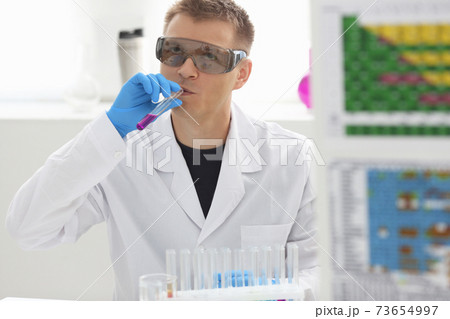 Employee of chemical laboratory teacher chemist tries homemade alcohol 73654997