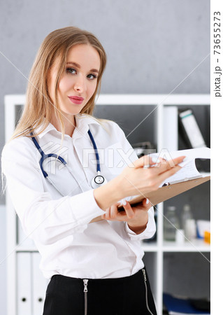 Beautiful smiling female doctor stand in office portrait 73655273