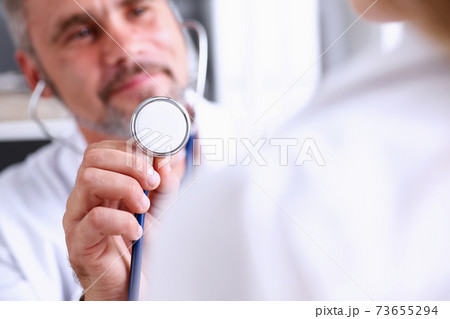 Male doctor hold in arm stethoscope head 73655294