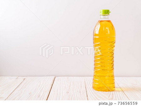 oil bottle on wood 73656559