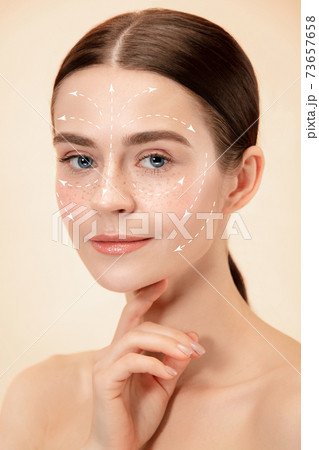 Beautiful female face with lifting up arrows isolated on studio background 73657658