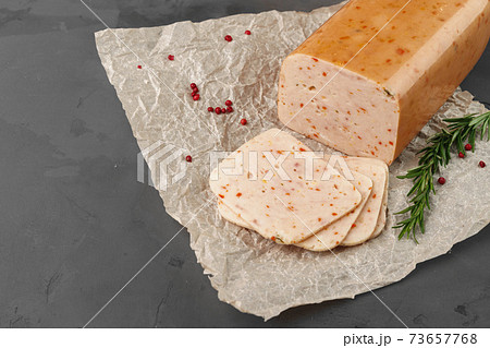 Meat sausage on parchment on gray background Meat sausage on parchment on gray background 73657768
