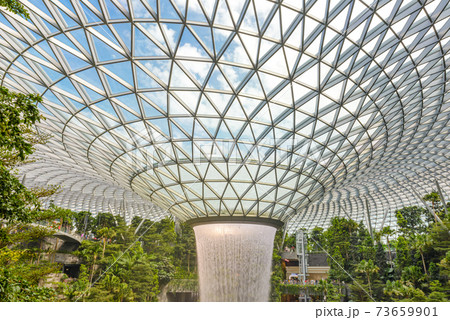 SINGAPORE - December 22, 2019: The largest indoor waterfall inside Jewel Changi Airport in Singapore SINGAPORE - December 22, 2019: The largest indoor waterfall inside Jewel Changi Airport in Singapore 73659901